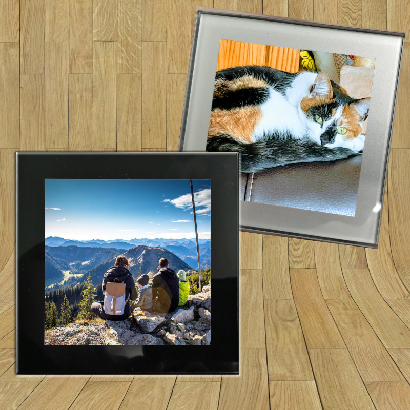 Personalised Glass coaster with black border and a photo of a family of 4 looking at the mountains and with silver border and a photo of a cat