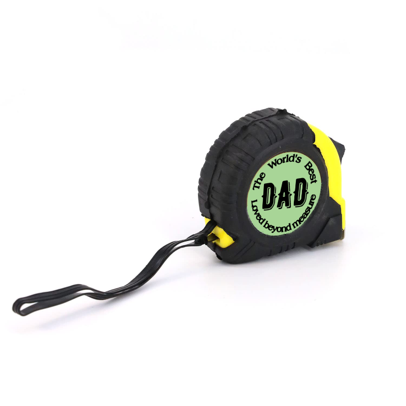A black and yellow tape measure with a wrist strap. The label reads "The World's Best DAD, Love beyond measure.