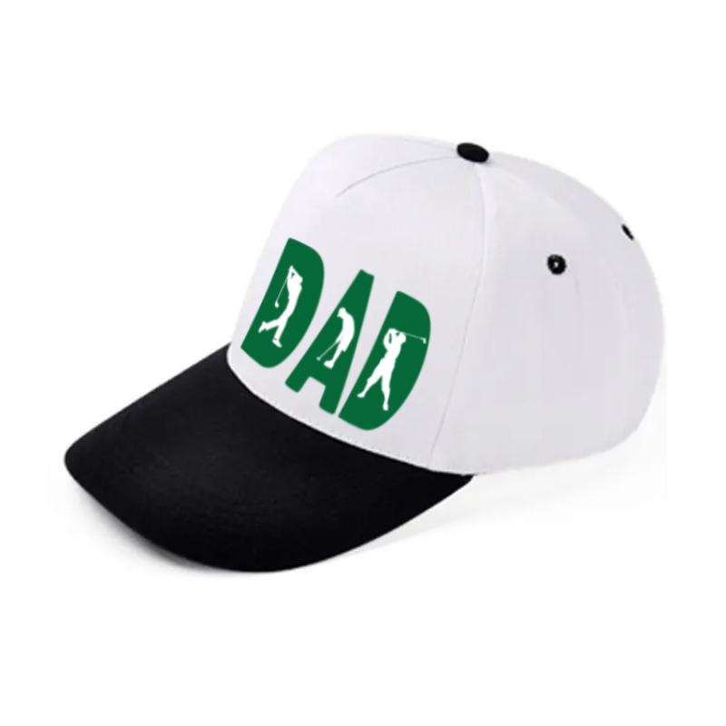 A white baseball cap with a black brim. The word "DAD" in green letters is on the front, with silhouettes of golfers swinging inside each letter.