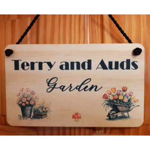 Personalised Wood Hanging Sign with black cord Personalised Wood Hanging Sign with black cord personalised: Terry and Auds Garden with flowers on the design