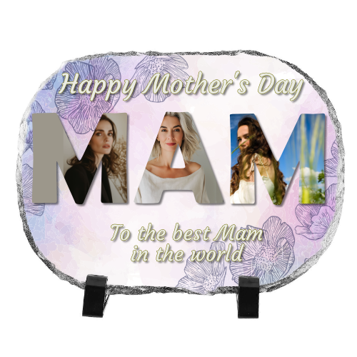 slate oval A personalised oval stone photo slate with a Mother's Day design. The slate features the word 'MAM' in large capital letters, with three different photos of a woman inside each letter. The background has a soft floral pattern in shades of purple, and the text reads 'Happy Mother’s Day' at the top and 'To the best Mam in the world' at the bottom in an elegant script font. The slate is displayed on two black stand legs.