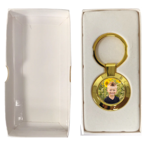 Round Metal Keyring - Gold in a white box, personalised with a photo of a boy in the fields.