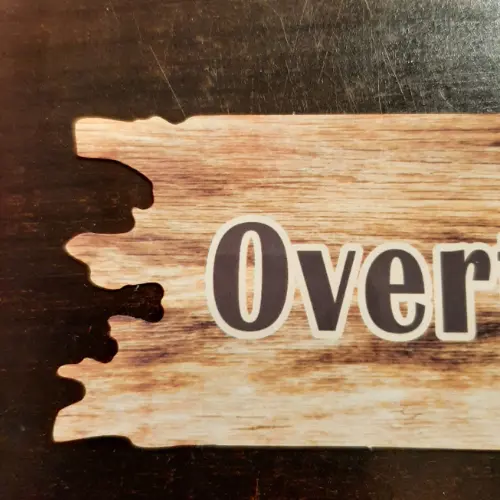 Zoom in to the left part of the Personalised Driftwood Shaped Metal Sign with wooden effect and text Overthink? Never!