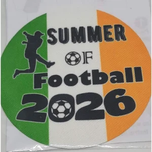 A round 75mm iron-on fabric patch featuring the Irish flag background. The text reads "Summer of Football 2026" in black lettering, accompanied by a black silhouette of a football player kicking a ball and two small football graphics.